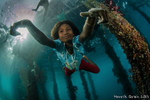 Papuan Girl Posing under Aborek Jetty by Henrik Gram Rasmussen 